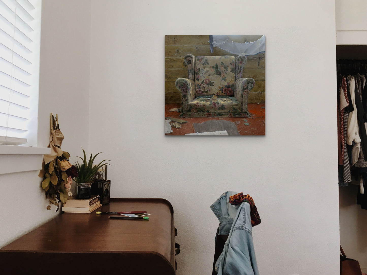 "Once Upon a Time" wall art piece captures an image of an old chair with a house about to collapse. This hyperrealist piece was by Mark McDermott.